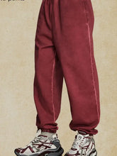 Mens elastic waist joggers in maroon with white sneakers
