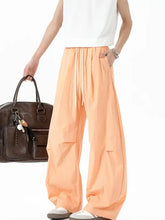 Mens elastic waist wide leg pants in peach, loose-fitting drawstring