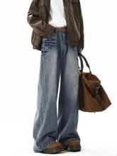 Men’s embellished wide leg jeans in blue denim with subtle distressing and silver studs on front pockets