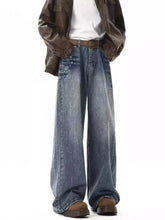 Men’s embellished wide leg jeans in medium-wash blue denim with subtle distressing and decorative stitching details