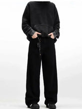 Black oversized hoodie with distressed sleeves and front pocket paired with men’s embroidered palm tree wide leg jeans