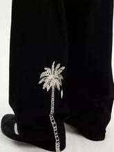 Men’s black wide leg jeans with a sparkling silver embroidered palm tree on the leg