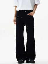Men’s black frayed hem flare jeans in denim with distressed detailing and silver rivets on back pockets visible