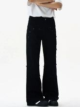 Black wide-leg denim flare jeans with frayed hem and silver rivets featuring distressed frayed edges and side details
