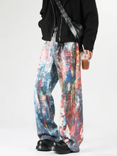 Men’s full size wide-leg jeans with vibrant abstract art print in red blue and white on denim fabric