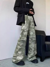 Men’s full size abstract print wide leg jeans with camouflage pattern and black graphic stitching in faded olive and gray