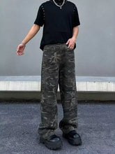 Men’s loose fit camo jeans in dark green and black camouflage print made from denim for a perfect fit and comfort