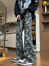 Men’s full size camo print relaxed fit jeans in muted green and gray made from premium cotton blend fabric
