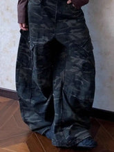 Men’s full size camo print wide leg jeans in dark green and black camouflage pattern with relaxed fit cargo style