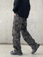 Men’s full size camouflage wide leg jeans in dark green and black with multiple cargo pockets and durable fabric