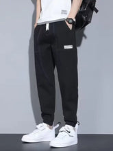 Men’s black denim cargo joggers with white drawstrings and thigh patch in loose fit casual loose style