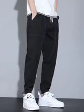 Men’s full size casual loose fit black denim joggers with white drawstrings and subtle stitching details