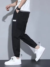 Men’s full size casual loose fit denim joggers in black with white thigh patch and elastic cuffs