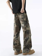 Men’s full size distressed camouflage wide leg jeans in muted green brown and black with multiple pockets and distressed detailing