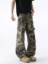 Men’s full size distressed camouflage wide leg cargo pants with distressed patches and relaxed fit in camouflage print