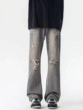 Men’s full size distressed loose fit gray denim jeans with frayed ripped knee patches and relaxed straight-leg cut