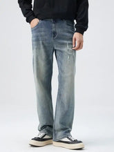 Distressed medium-wash denim jeans in loose fit plus size with straight-leg cut for men