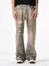 Men’s full size distressed jeans in gray denim with loose fit and distressed detailing including faded wash and rips