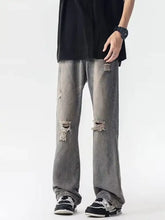 Men’s full size distressed loose fit gray denim jeans with frayed ripped knees and relaxed straight-leg cut