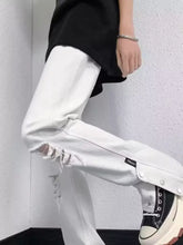 Men’s white distressed loose fit denim jeans with frayed knees and snap button cuffs in plus size fit jeans