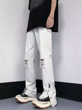 Men’s full size white distressed denim loose fit jeans featuring raw-edge ripped knees and buttoned fly ankles