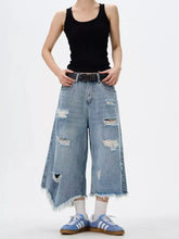 Men’s light-wash denim wide leg jeans with distressed patches and raw hem frayed edges plus size culottes