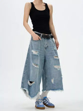 Men’s light-wash denim wide leg jeans with distressed frayed holes and raw hem in plus size design