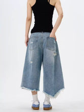 Light-wash denim men’s wide leg jeans with raw hem frayed edges and distressed patches plus size culottes