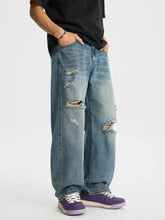 Men’s blue distressed denim relaxed fit baggy jeans with multiple ripped patches and wide-leg cut full size plus size