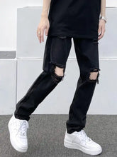 Men’s full size distressed slim fit black denim jeans with ripped and frayed holes at the knees