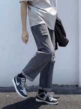 Men’s full size gray distressed straight-leg jeans with relaxed fit and rolled cuffs in denim material