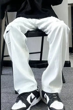 Men’s white distressed wash wide leg jeans with relaxed fit and visible wear patterns plus size full size