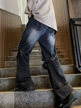 Men’s full size distressed wide leg jeans in dark wash denim with black metal buckles and reinforced thigh patches