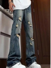 Men’s full size distressed blue denim wide leg jeans with multiple ripped patches and frayed edges