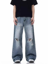 Men’s full size distressed wide leg jeans in faded blue denim with ripped knees and a size distressed wide leg fit