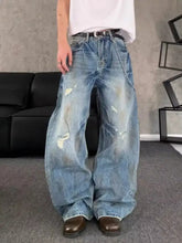 Men’s full size washed blue denim jeans with distressed wide leg cut and ripped details in plus size design
