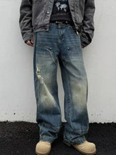 Men’s full size washed blue denim wide leg jeans with distressed faded patches and a relaxed wide leg cut