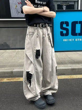 Men’s full size distressed wide leg jeans in beige denim with black patches and chain detailing