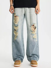 Men’s full size distressed wide leg jeans in light-wash denim with frayed holes on the thighs