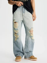 Men’s full size distressed wide leg jeans in light-wash denim featuring frayed holes on the thighs