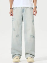 Men’s full size light-wash denim distressed wide leg jeans with relaxed fit and intentional patch detailing