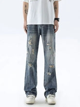 Men’s full size distressed wide leg jeans in distressed blue denim with multiple ripped patches and faded wash