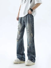 Men’s full size distressed wide leg jeans in blue distressed denim with intentional rips and frayed edges