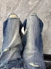 Men’s full size distressed wide leg jeans offer distressed details with frayed ripped knees and faded blue denim wash