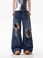 Men’s full size dark blue distressed wide leg jeans with frayed holes at the knees made of denim material