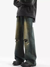 Men’s full size distressed wide leg jeans in dark green and black denim with intentional knee rips