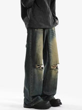 Men’s full size distressed wide leg jeans in dark wash denim with intentional knee rips and faded weathered patches