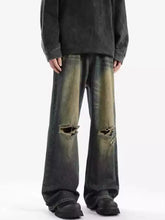Men’s full size dark-wash distressed wide leg jeans with ripped knees and faded greenish-yellow patches