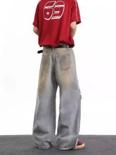 Men’s full size distressed wide leg jeans in faded gray denim with distressed patches and black belt accessory