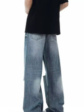 Men’s full size distressed wide leg jeans in faded light blue denim with frayed hems and distressed details